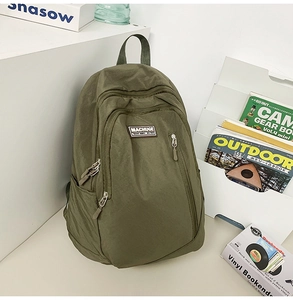 Close-up of military green nylon backpack with durable texture and functional zippers