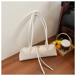 Close-up of white woven shoulder bag texture with long fringe zipper and elegant tassels