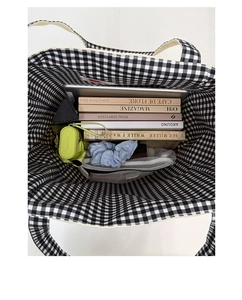 Top view of spacious checkerboard canvas tote showing laptop and daily essentials inside