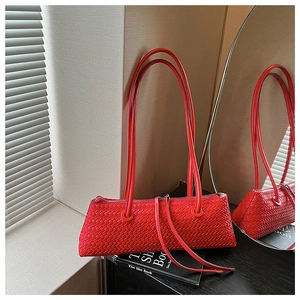 Close-up of red woven leather texture and zipper detail on this luxury underarm bag