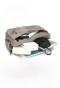 Detailed internal compartments of khaki nylon bag showing tablet, power bank and umbrella