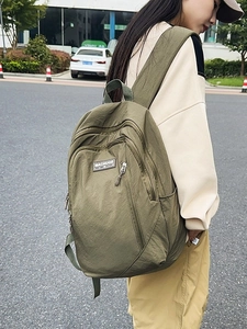 Minimalist military green nylon backpack with large capacity for urban commuting and travel