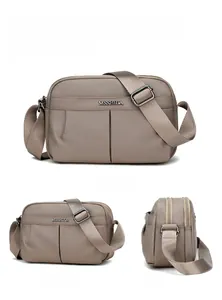 Detailed views showing the water-resistant nylon texture and metal logo of the square bag
