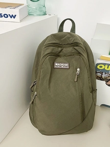 Minimalist olive green nylon backpack for women with front zip pocket and side pouches