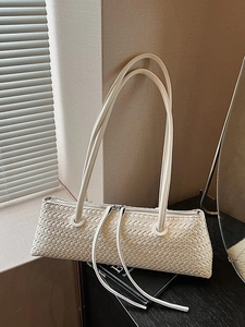 Minimalist woven baguette shoulder bag in cream white with stylish textured finish