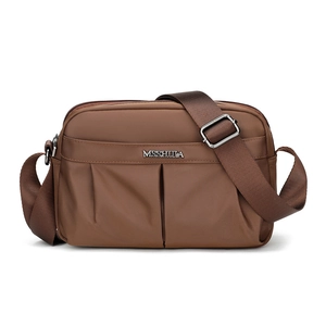 Detail of coffee brown crossbody bag with adjustable wide strap and metallic brand logo