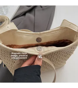 Dettaglio della borsa in pelle intrecciata con chiusura magnetica e fodera in tessuto