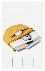 Detailed interior storage of yellow canvas saddle bag showing spacious compartments