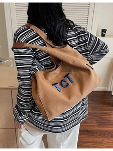 Minimalist canvas shoulder bag with TCT embroidery and leather straps in khaki brown
