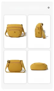 Detail view of yellow nylon crossbody bag with dual zippers and adjustable wide strap