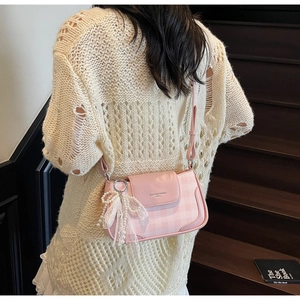 Pink checkered underarm bag featuring a delicate lace pearl bow charm and magnetic flap