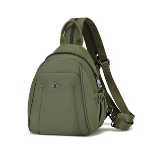 Detail of olive green nylon bag showing metal logo and side elastic pocket detail