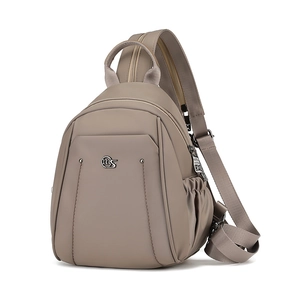 Detail view of the durable taupe oxford fabric and side drawstring pocket of this backpack