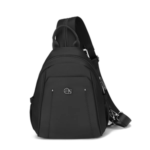 Detail showing high-density oxford fabric and silver metal logo on black backpack