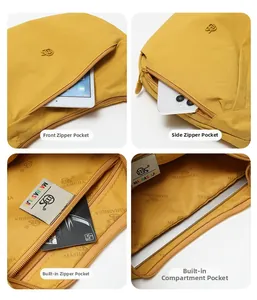 Detail view of ginger yellow canvas bag showing multiple zippers and internal compartments