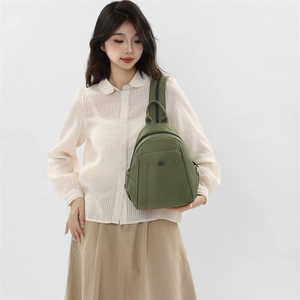 Olive green waterproof nylon backpack with front zippered pocket and metallic logo detail