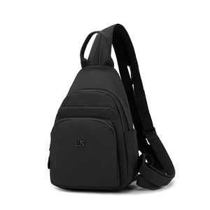 Detail view of black oxford fabric crossbody bag with wide strap and multiple zippers