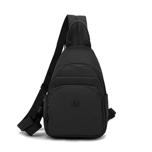 Detail view of black oxford fabric cross-body bag showing front zipper and adjustable strap