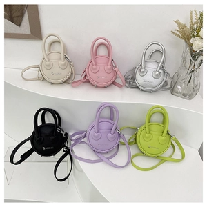 Mini circular crossbody bags in six colors featuring pebble leather and star logo detail