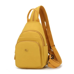 Close-up of yellow waterproof oxford fabric texture and MS brand logo on a crossbody bag
