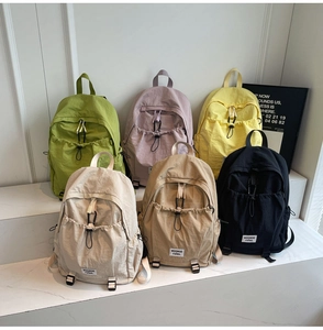 Group display of high-capacity nylon backpacks in six colors including green and purple