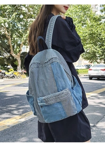 Side view of a vintage denim patchwork backpack showing large capacity and side pockets