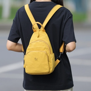 Detail of vibrant yellow waterproof oxford cloth mini backpack with adjustable straps