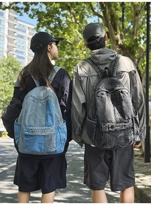 Outdoor shot of vintage washed denim backpacks in light blue patchwork and dark grey