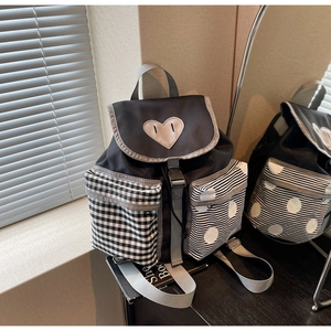 Detailed view of the large capacity backpack featuring unique heart patch and mixed patterns