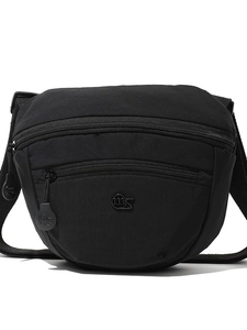 Minimalist black nylon crossbody saddle bag with metal zippers and adjustable strap