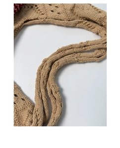 Detailed close-up of khaki crochet knit texture and handcrafted weave pattern of the tote bag