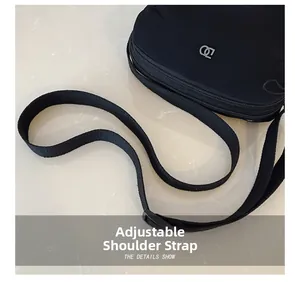 Detail of waterproof nylon bag showing adjustable strap and smooth metal double zippers