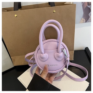 Detailed macro view of light purple circular bag featuring litchi grain texture