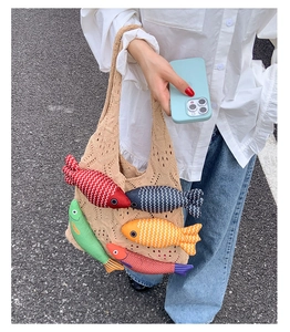 Detail of knit tote bag featuring colorful 3D fish ornaments and wave pattern texture