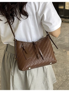 Dark brown woven leather crossbody tote bag for women shown on a model for daily use