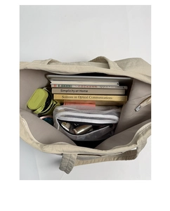 Top-down view of a spacious beige canvas tote bag with herringbone lining showing large capacity