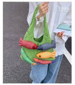 Detail of green knit tote bag featuring colorful 3D stuffed fish and fringe accents