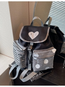 Stylish patchwork backpack with heart charm and polka dot patterns for casual daily travel