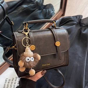 Retro dark brown leather handbag with gold buckle and plush charm for women