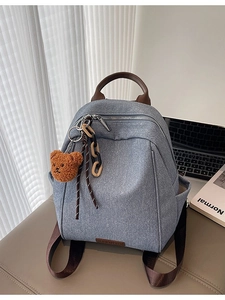 Minimalist colorblock blue canvas backpack with brown straps and cute bear pendant charm