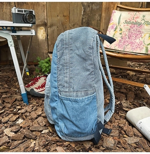 Detail of blue corduroy and denim patchwork backpack with adjustable nylon straps