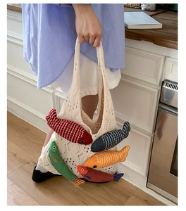 Close-up of crochet tote bag featuring colorful padded fish charms in a cozy kitchen