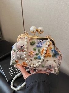 Floral knit-pattern shell bag featuring a pearl handle and gold metallic clasp
