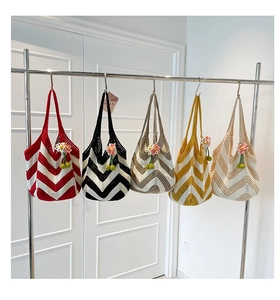 Detail of woven tote bags with V-shaped stripe patterns and handmade flower charms