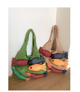 Detail of knit tote bags featuring colorful fish plush charms and hollow crochet texture