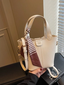 Elegant beige bucket bag with lychee texture leather and a stylish houndstooth silk scarf