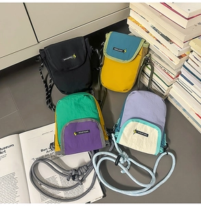 Detailed close-up of nylon mini phone crossbody bags in four trendy color combinations