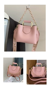 Pink bucket bag detail with metal handle, decorative chain and logo-printed wide strap