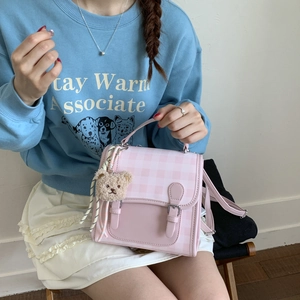 Pink checkered PU leather bag featuring a flap closure and a cute brown plush bear charm