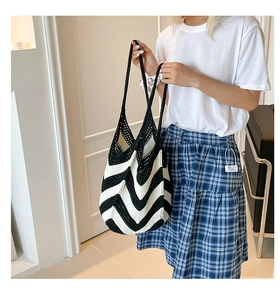 Detail shot of black and white chevron knit shoulder bag with crochet woven texture